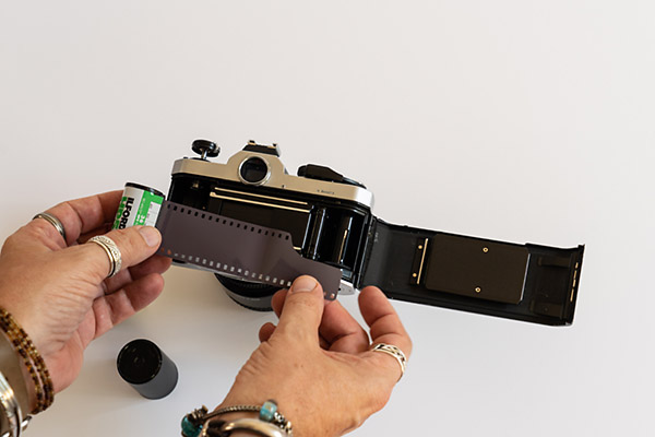 Insert end into sprocket - How To Load 35mm Film