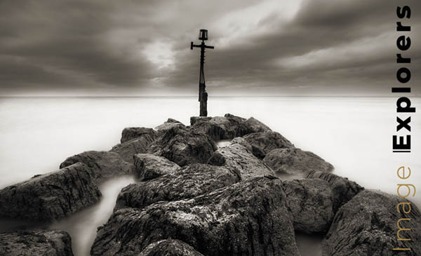Long nd filter image for misty water on beach in black and white